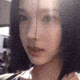 a close up of a woman 's face with a blurred background .