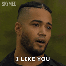 a man with a beard says " i like you " in front of a skymed logo