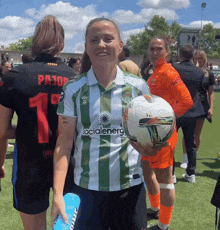 a woman in a green and white striped shirt that says socialenerg