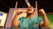 a man in a scrub top with the letter h on the front