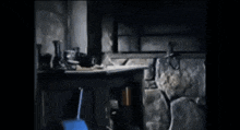 a man in a cowboy hat sits on a table in a dark room