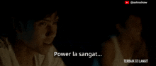a man is smiling in the dark with the words power la sangat written below him