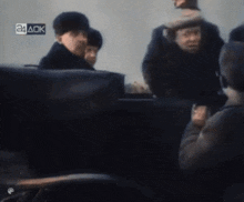 a group of people sitting in a car with a sign that says 24 aok on it