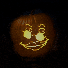 a pumpkin with a face carved into it with glasses on