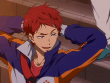 a man with red hair is wearing a blue and orange jacket with columbia on it