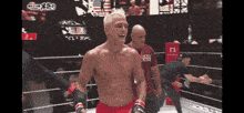 a man standing in a boxing ring with a shirt that says ' ufc ' on it