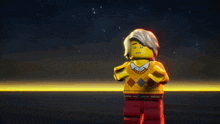 a lego man with gray hair and a yellow sweater with a checkered pattern