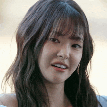 a close up of a woman 's face with a serious look on her face