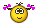 a yellow smiley face with a crown on top of it is holding a book and waving .
