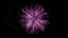 a man in a suit and tie stands in front of a fireworks display that says " happy new year "
