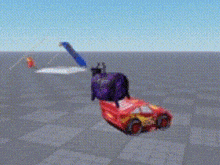 a red toy car is flying in the air