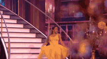 a woman in a yellow dress is dancing on a stage