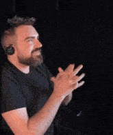 a man with a beard wearing a pair of headphones with the letters jbl on them