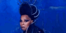 a woman is wearing a crown and a purple collar .