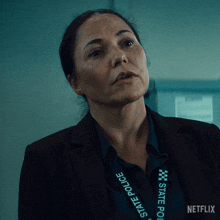 a woman with a lanyard that says state police