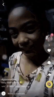 a girl is making a funny face in a video on a cell phone