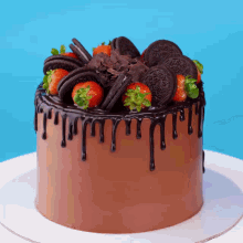 a chocolate cake with oreos and strawberries on top of it