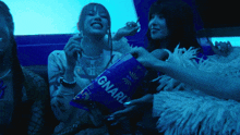 a woman is holding a bag that says gnarl on it