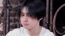 a close up of a person 's face with black hair