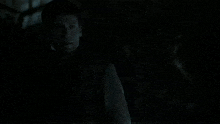 a man and a woman are kissing in a dark room