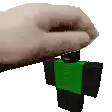 a hand is holding a green and black roblox figure .