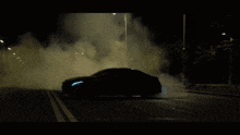 a car is driving down a street with smoke coming out of the exhaust pipe