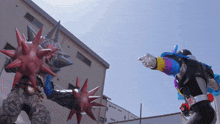 a cartoon character with spikes on his arms is fighting another cartoon character