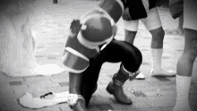 a person in a superhero costume is kneeling down on the ground