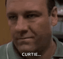 a close up of a man 's face with the word curtie on it .