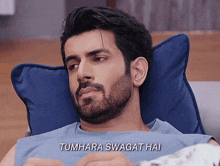 a man laying on a pillow with the words tumhara swagat hai written on the bottom