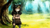 a boy in a cat costume is standing next to a tree in a field .