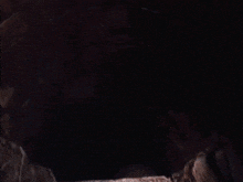 a man in a plaid shirt is flying through a dark tunnel