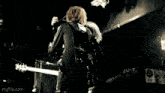 a couple of people giving each other a high five in a dark room ..