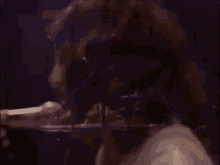 a man is singing into a microphone on a stage .
