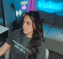 a woman wearing a t-shirt that says " how hard can it boys do it "