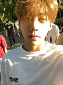 a young man wearing a white shirt that says balenciaga