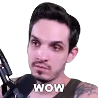 a man with a beard is holding a microphone and the word wow is on his face