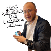 a man wearing glasses is holding a cell phone with a sticker that says " não e querendo ser machista mas "
