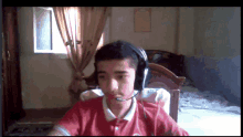a boy wearing headphones looks at the camera