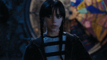 a girl with braids in her hair and a striped shirt