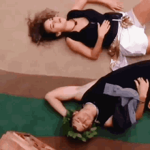 a man and a woman are laying on the floor with their arms outstretched