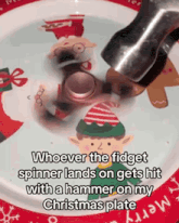 a fidget spinner on a christmas plate with a hammer