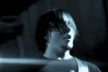 a blurry picture of a man 's face with a light shining on it