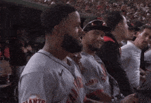 a group of giants baseball players are sitting in the stands