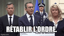 a group of people are standing in front of microphones with the words retablir l' ordre written on the bottom
