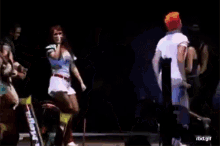 a group of people are dancing on a stage with a gif that says rbd.gif in the corner