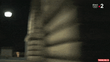 a blurred image of a building with the number 2 visible