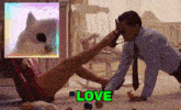 a man is putting his foot on a woman 's leg in a room with the word love in green .