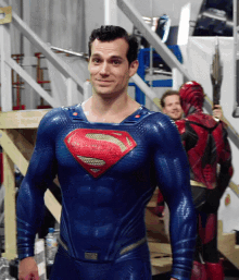 a man in a superman costume is smiling