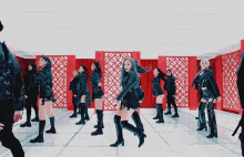 a group of women are dancing in a room